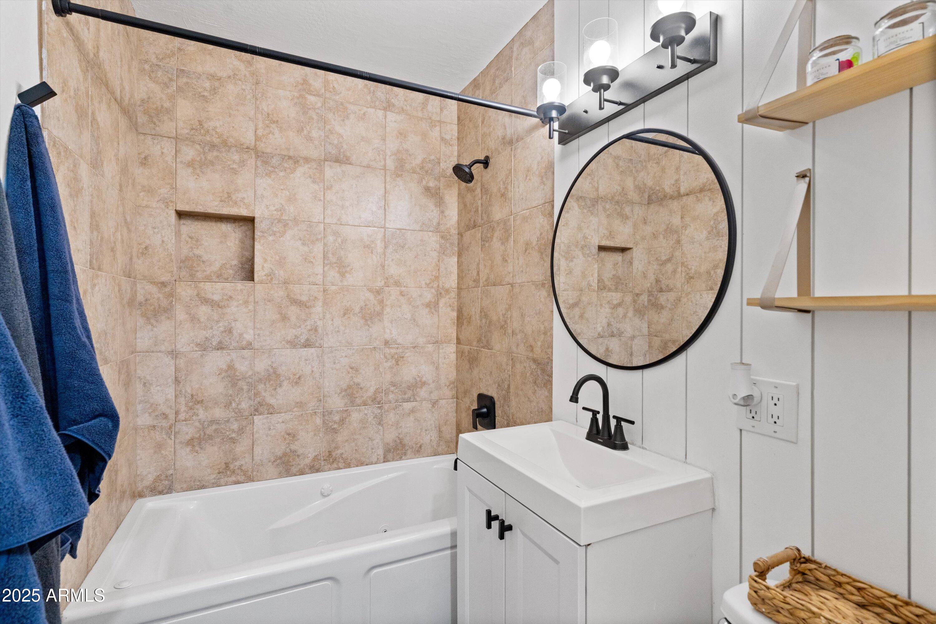 2201 East Weldon Avenue Phoenix, AZ 85016 - Photo 27 of 41 a bathroom with a sink a mirror and a shower