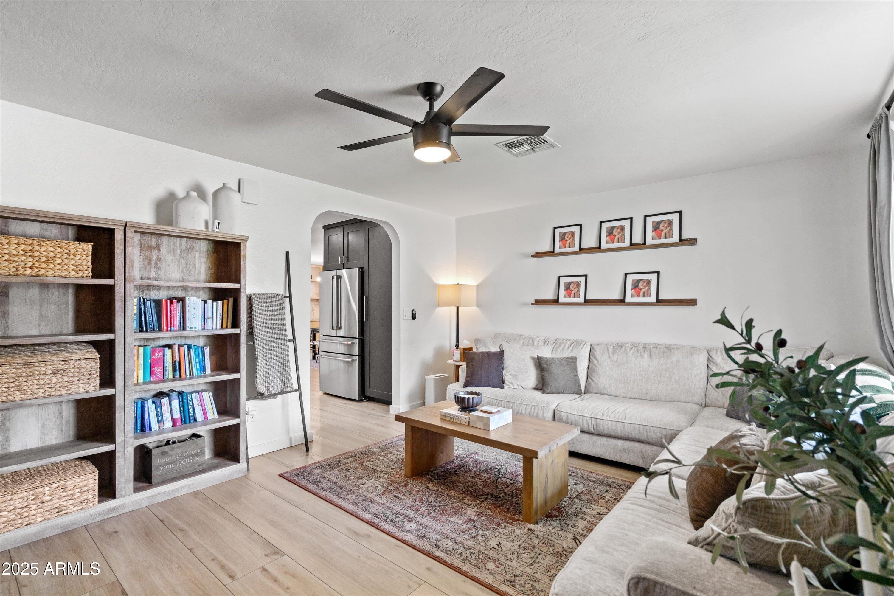 2201 East Weldon Avenue Phoenix, AZ 85016 - Photo 8 of 41 a living room with furniture and a book shelf
