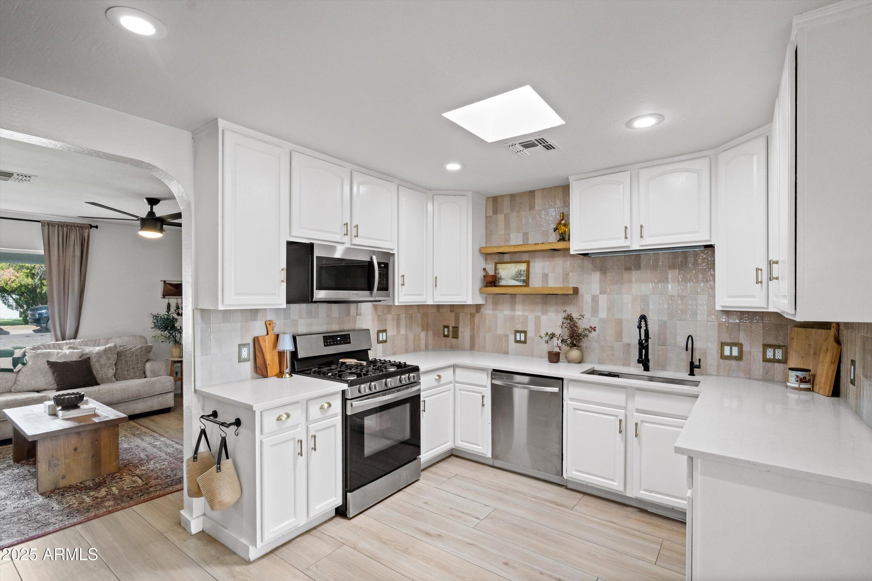 2201 East Weldon Avenue Phoenix, AZ 85016 - Photo 9 of 41 a kitchen with granite countertop a sink a stove and cabinets