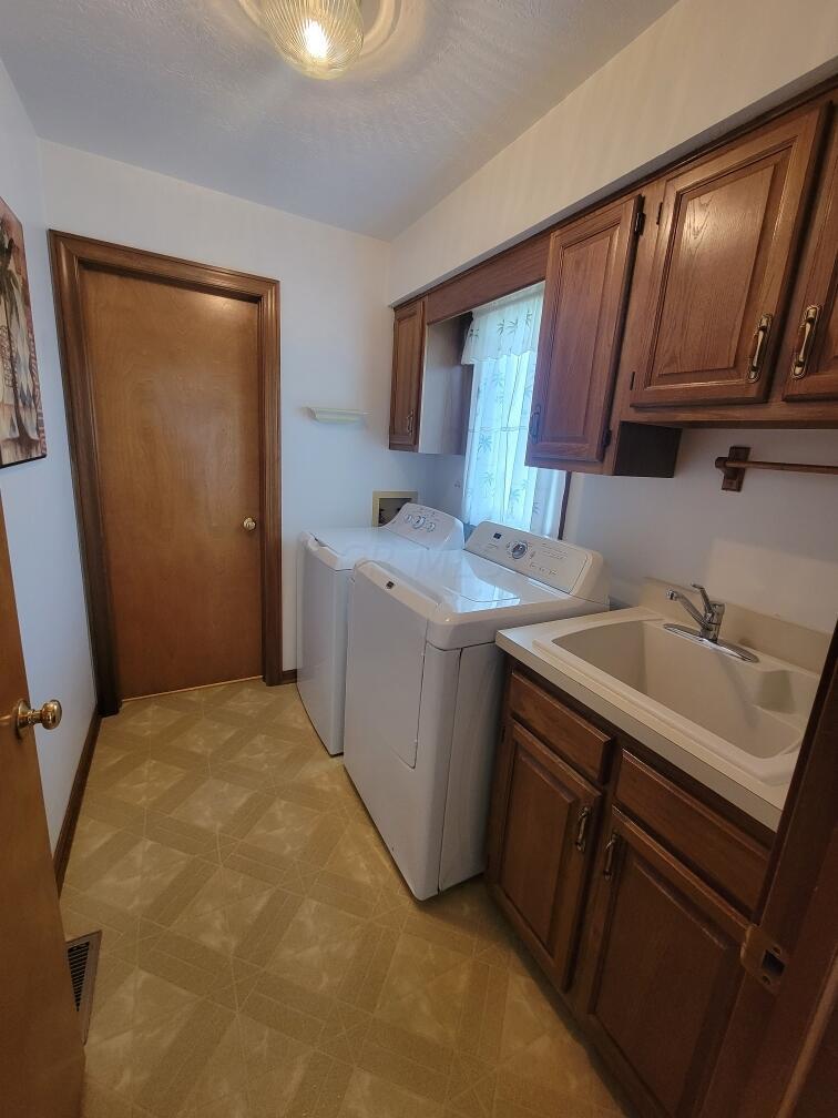 7245 Plumb Road Galena, OH 43021 - Photo 22 of 33 First Floor Laundry with cabinets and sink