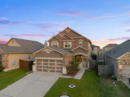a view of a chair and table in backyard of the house