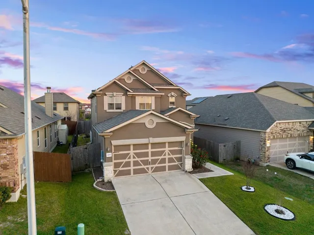 a front view of a house with a yard table and chairs