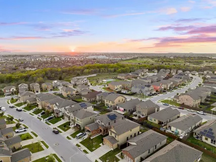 an aerial view of a house with outdoor space and city view