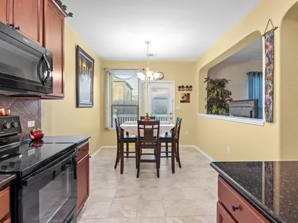 a kitchen with stainless steel appliances granite countertop a refrigerator stove and sink