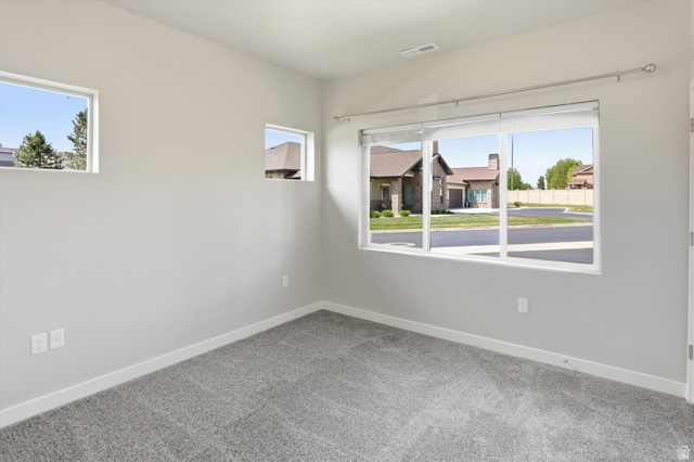 1838 West 300th Street South, Unit B Mapleton, UT 84664 - Photo 26 of 51 Carpeted interior space featuring light gray wall paint, multiple windows, and white trim