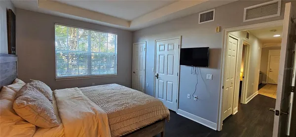 a bedroom with a bed and a flat screen tv