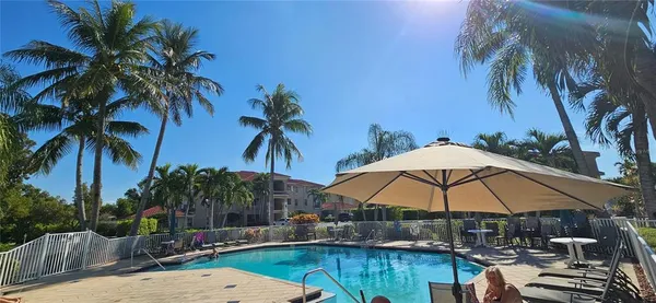 a view of a backyard with swimming pool and furniture