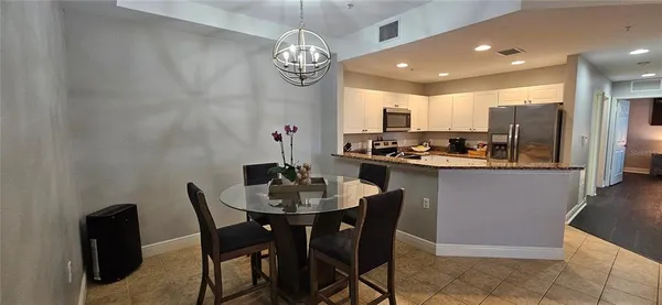 a kitchen with a dining table and chairs