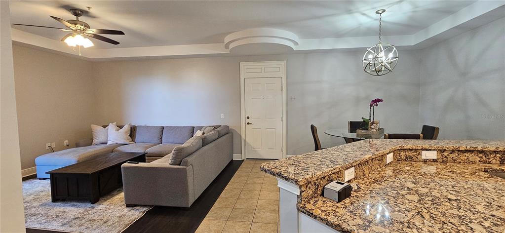 1502 Southwest 50th Street, Unit 104 Cape Coral, FL 33914 - Photo 5 of 18 a bed room with a bed and a chandelier