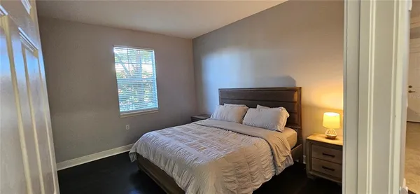 a bedroom with a bed and window
