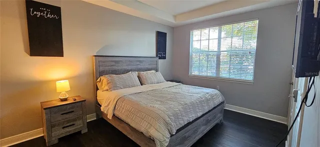 a bed sitting in a bedroom next to a window