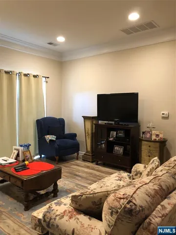 a bedroom with a bed and a television