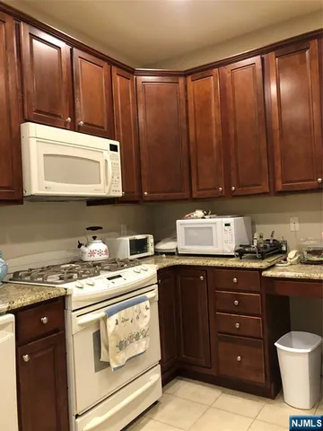 a kitchen with a cabinets and a stove top oven