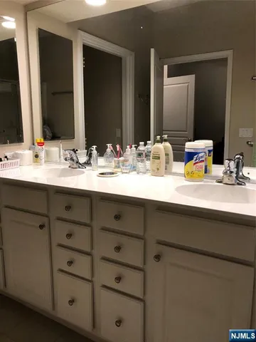 a bathroom with a double vanity sink and a mirror
