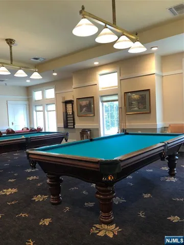 a room with pool table and windows