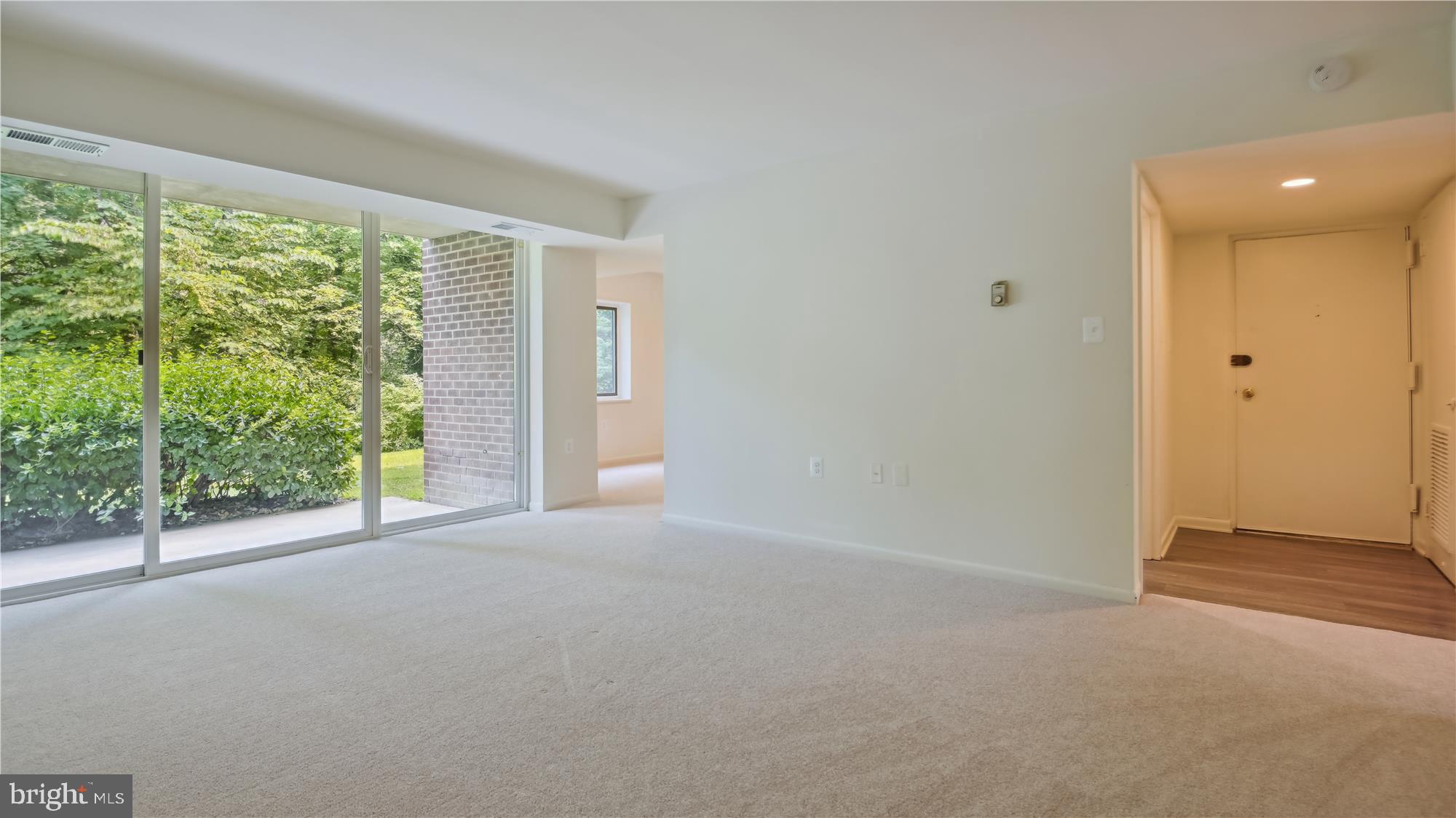 1429 Northgate Square, Unit 1C Reston, VA 20190 - Photo 7 of 25 Living Room opens to Dining, Foyer and Patio