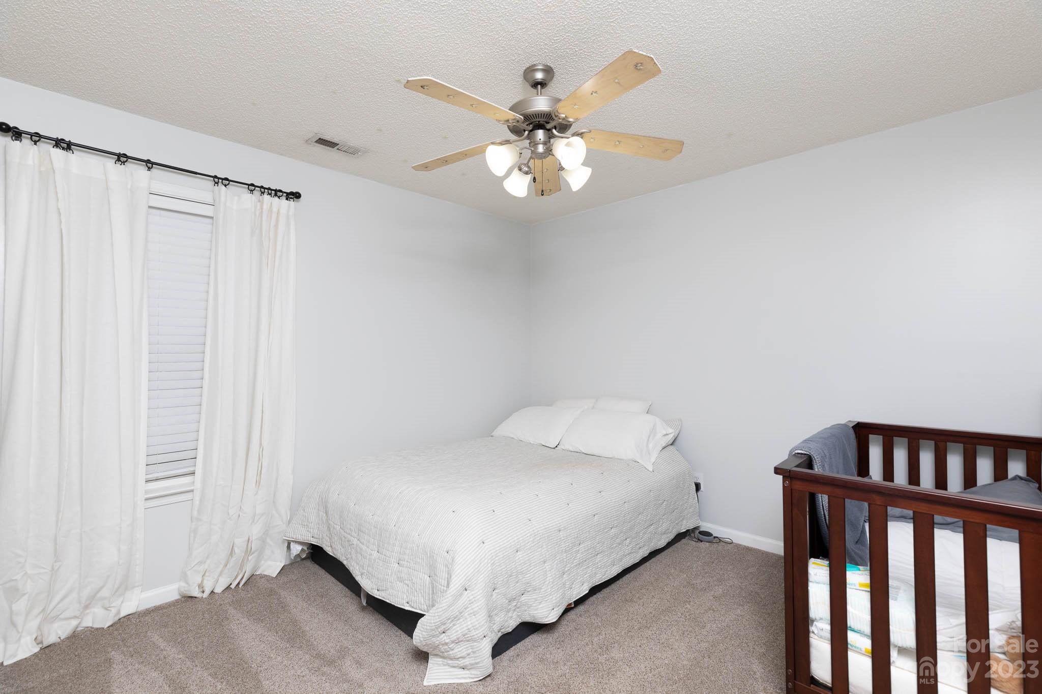 1503 George Dunn Road Rock Hill, SC 29730 - Photo 13 of 21 a bedroom with a bed and a chandelier