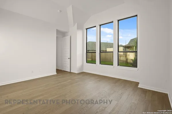 a spacious bathroom with a tub sink and mirror