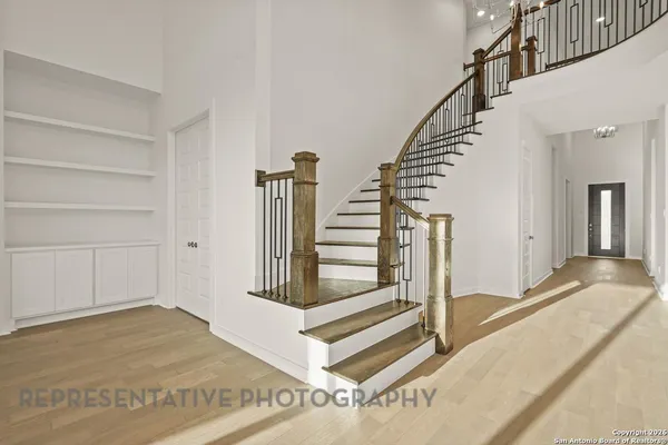 a view of entryway and hall with wooden floor