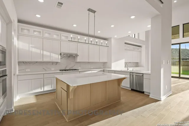 a kitchen with a sink window and cabinets