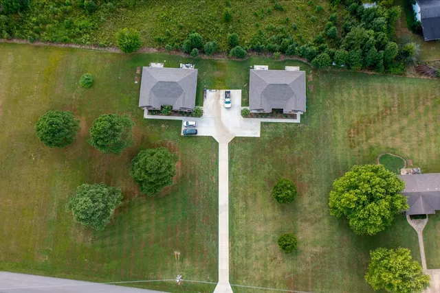 an aerial view of a residential houses with outdoor space