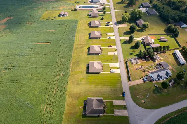 a view of house that has a yard