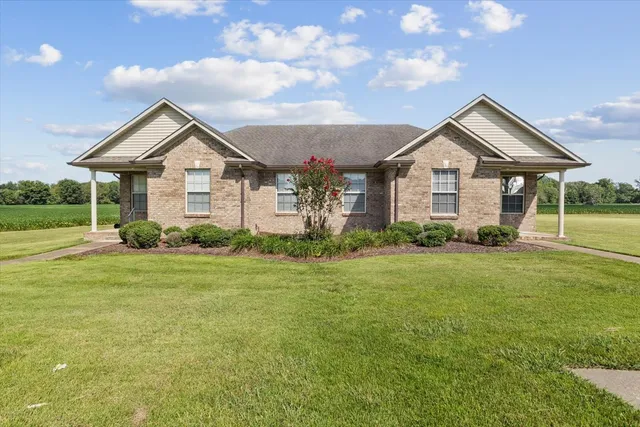 a front view of a house with a yard