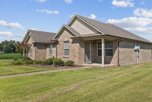 a front view of a house with a garden