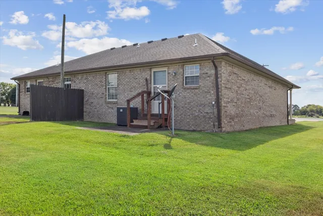a front view of a house with a garden and yard