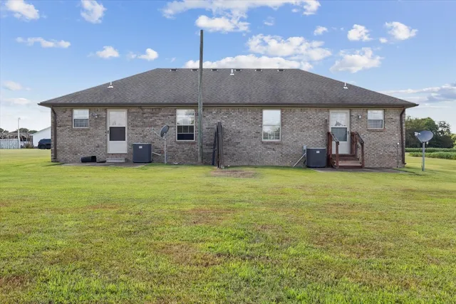 a view of a house with a garden and pathway