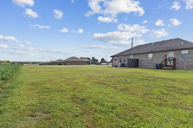 a kitchen with stainless steel appliances kitchen island granite countertop a sink dishwasher stove and cabinets
