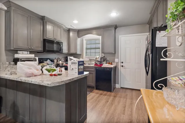 a bedroom with bed and a wooden floor
