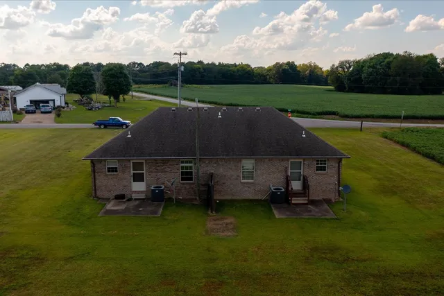 a aerial view of a house next to a big yard