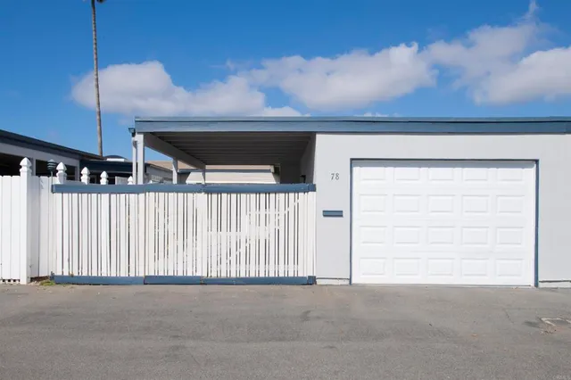 a view of building and yard with swimming pool and outdoor seating