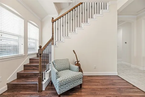 a view of entryway and hall with wooden floor