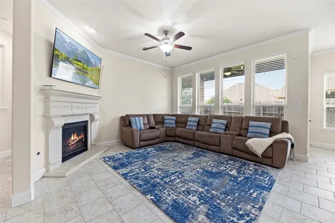 a living room with furniture fireplace and window