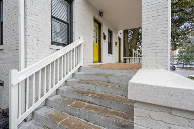 a view of a house with a door and wooden floor