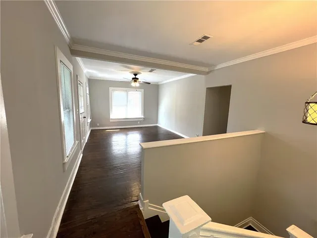 a view of a room with wooden floor and windows
