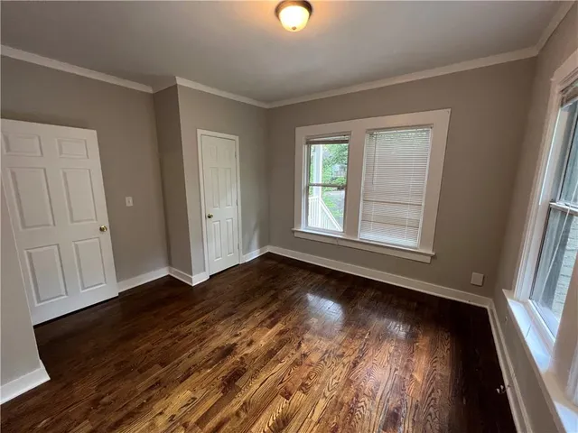 a kitchen with wooden floors and stainless steel appliances
