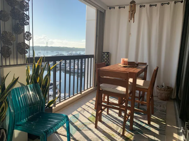 a view of a balcony with chairs and wooden floor