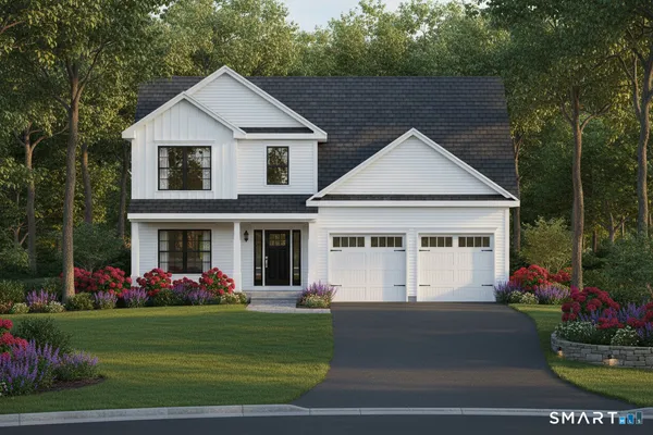 a front view of a house with a yard and potted plants