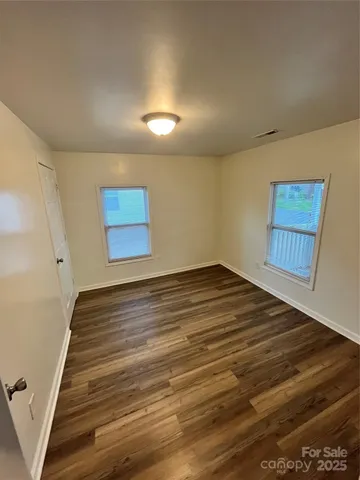 a view of an empty room and wooden floor