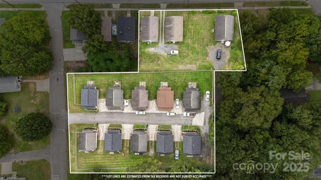 an aerial view of a residential houses with outdoor space and street view