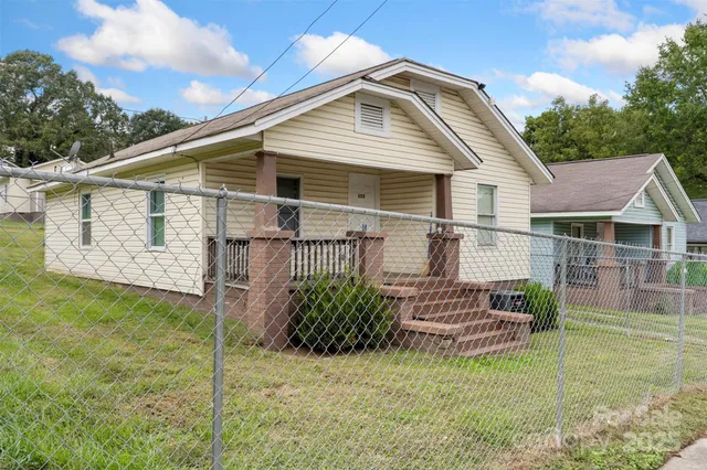 a view of a house with wooden fence