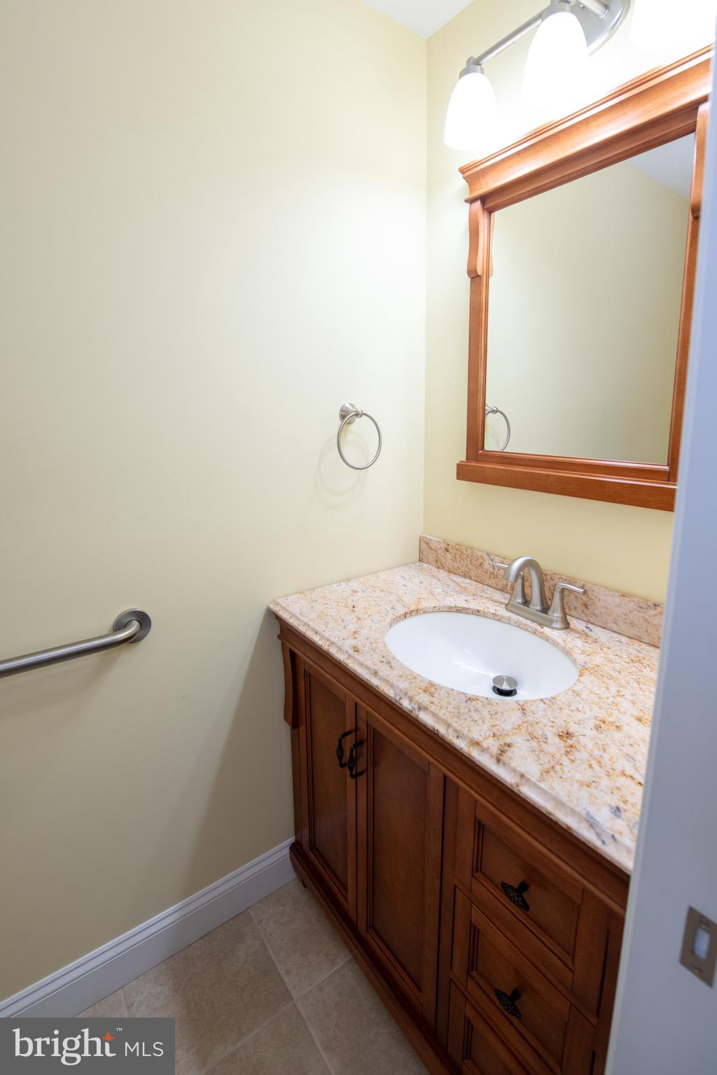 3210 Ancona Road Philadelphia, PA 19154 - Photo 17 of 46 a bathroom with a granite countertop sink and a mirror