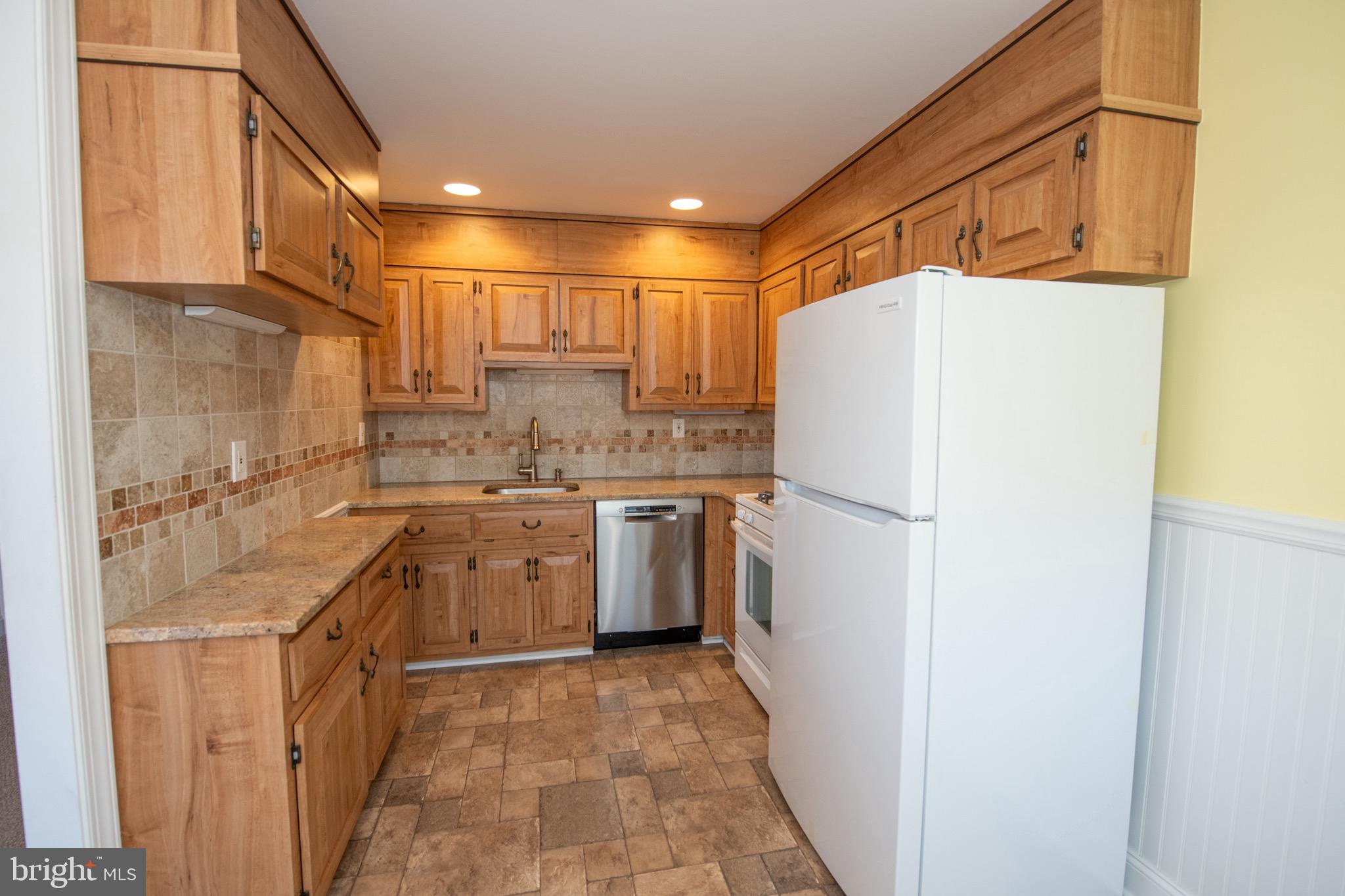 3210 Ancona Road Philadelphia, PA 19154 - Photo 22 of 46 a white refrigerator freezer sitting inside of a kitchen