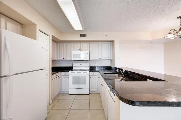 a kitchen with a stove a refrigerator and a sink
