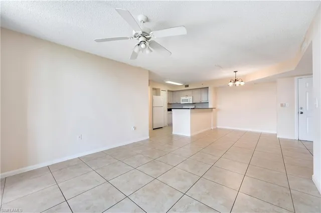 a view of a kitchen with a microwave and white cabinets