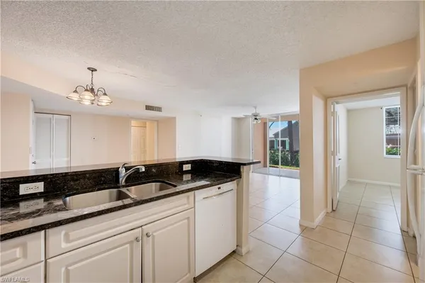 a kitchen with granite countertop a sink and cabinets
