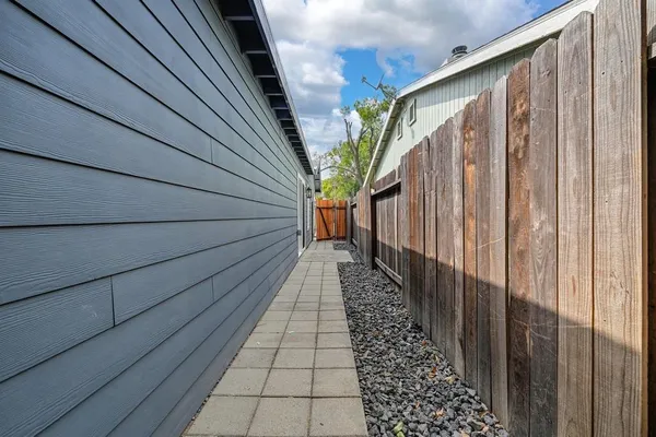 a kitchen with stainless steel appliances kitchen island granite countertop a sink and a refrigerator